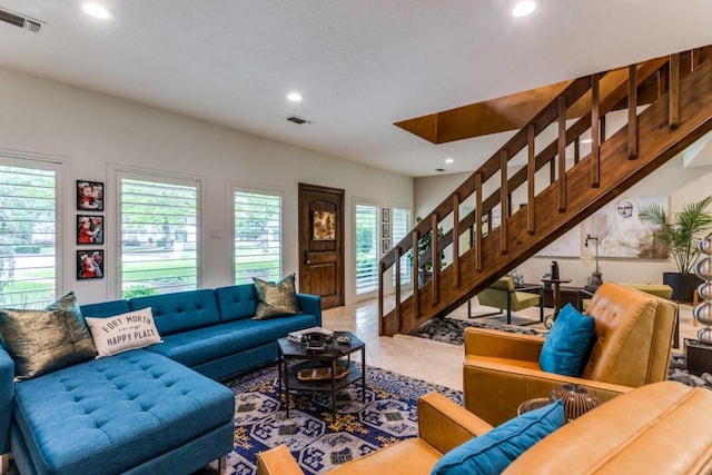 tiled living area with recessed lighting, visible vents, and stairs