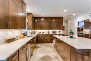 kitchen with a kitchen island, built in appliances, and modern cabinets