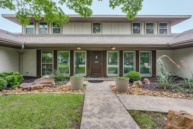 view of front of property featuring covered porch and brick siding