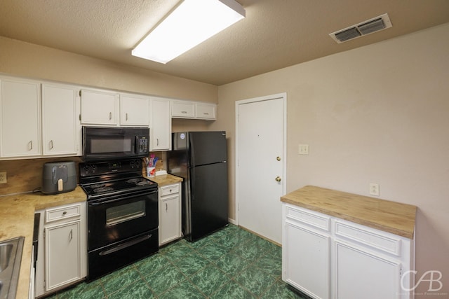 3749 Oldham Ln, Abilene, TX 79602 - kitchen with dark floors, white cabinetry, visible vents, a textured ceiling, and black appliances