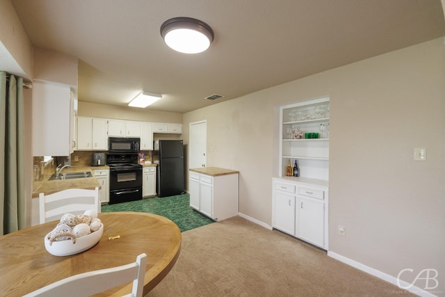 3749 Oldham Ln, Abilene, TX 79602 - kitchen featuring black appliances, visible vents, light countertops, white cabinets, and dark carpet