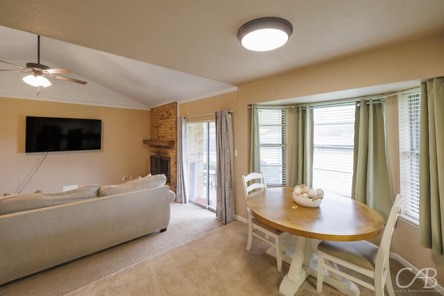 3749 Oldham Ln, Abilene, TX 79602 - living room with vaulted ceiling, light colored carpet, a brick fireplace, and a ceiling fan