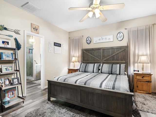 bedroom with baseboards, visible vents, a ceiling fan, and wood finished floors