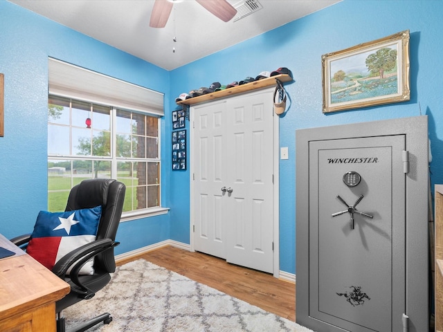 office space with ceiling fan, baseboards, visible vents, and wood finished floors