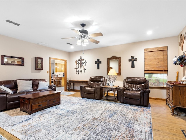 living area featuring ceiling fan, recessed lighting, visible vents, and light wood-style floors