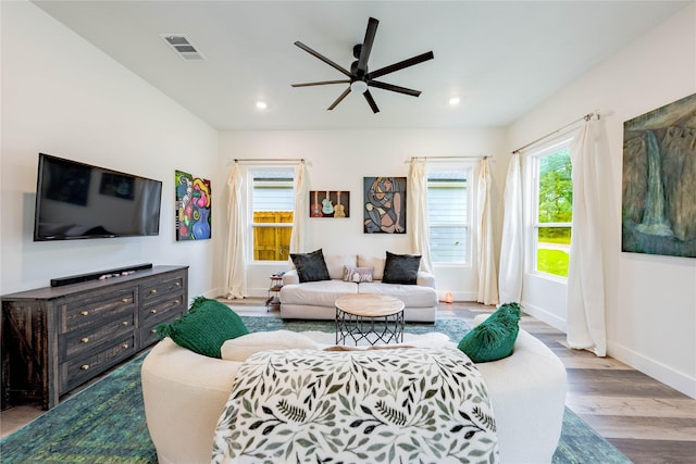 living room with a ceiling fan, recessed lighting, baseboards, visible vents, and wood finished floors
