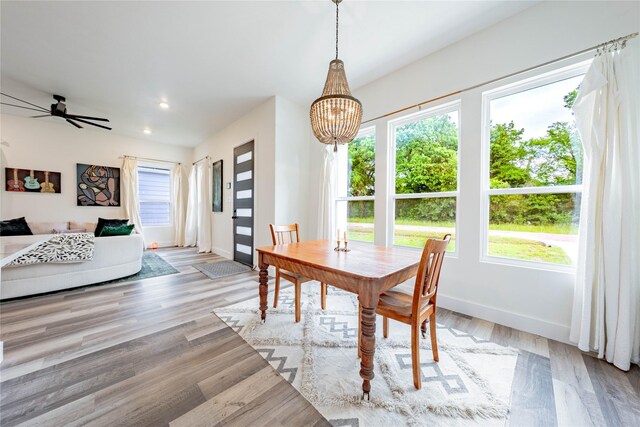 dining space featuring baseboards, recessed lighting, plenty of natural light, and wood finished floors