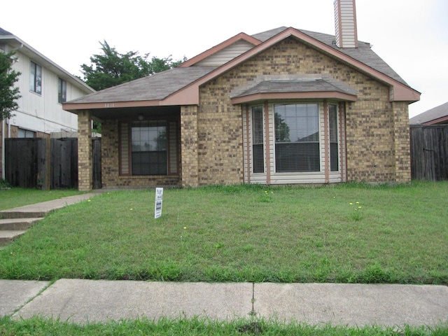 1431 Windmill Ln, Mesquite, TX 75149 - view of front facade featuring brick siding, fence, and a front yard