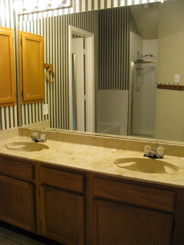 1431 Windmill Ln, Mesquite, TX 75149 - bathroom featuring a sink, double vanity, walk in shower, and wallpapered walls