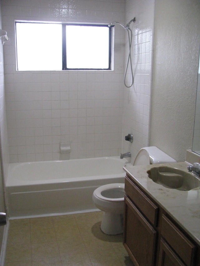 1431 Windmill Ln, Mesquite, TX 75149 - full bath featuring toilet, tile patterned flooring, vanity, shower / bathing tub combination, and a textured wall