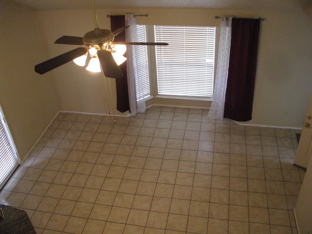 1431 Windmill Ln, Mesquite, TX 75149 - unfurnished room with a wealth of natural light, baseboards, light tile patterned flooring, and ceiling fan