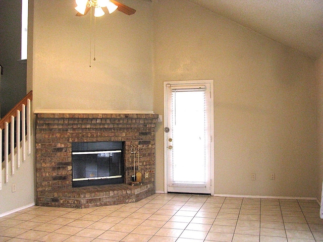 1431 Windmill Ln, Mesquite, TX 75149 - unfurnished living room with a ceiling fan, high vaulted ceiling, a brick fireplace, baseboards, and light tile patterned flooring