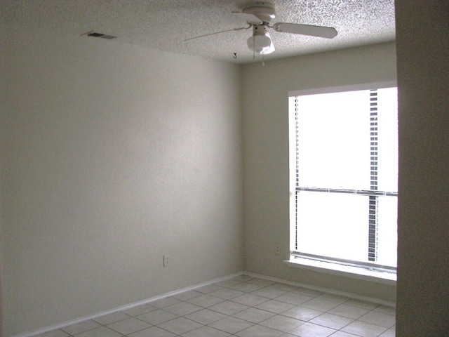 1431 Windmill Ln, Mesquite, TX 75149 - spare room featuring a ceiling fan, a textured ceiling, baseboards, light tile patterned floors, and visible vents