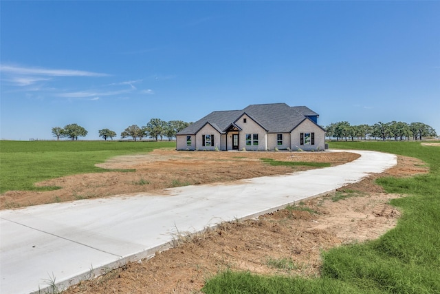modern farmhouse style home with a front lawn and driveway