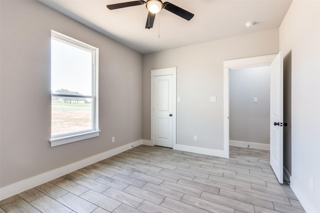 unfurnished bedroom with baseboards, light wood finished floors, and ceiling fan
