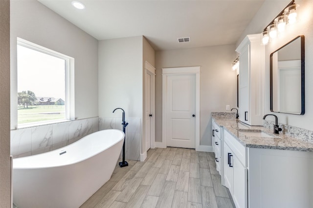 2017 Swallowtail Ct, Poolville, TX 76487 - bathroom with a sink, a soaking tub, double vanity, and visible vents