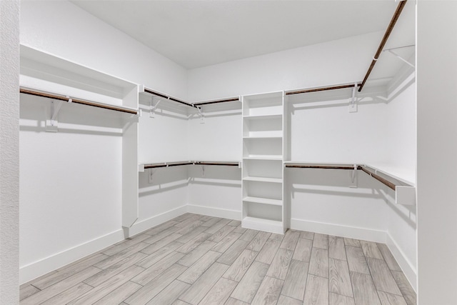 walk in closet featuring light wood-style floors