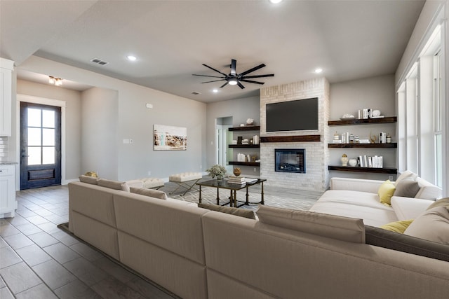 living area featuring visible vents, a fireplace, ceiling fan, and recessed lighting