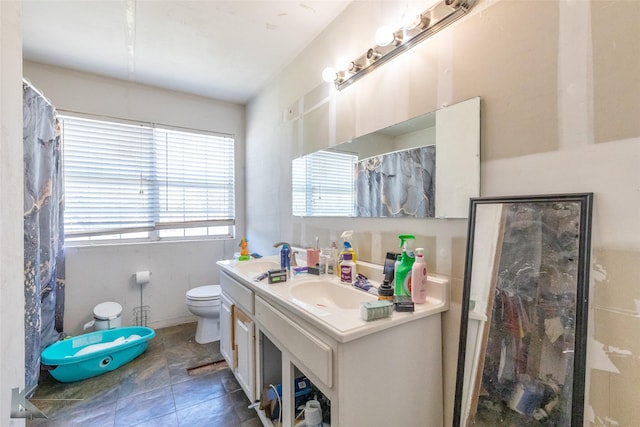 full bathroom with toilet, vanity, and a shower with shower curtain