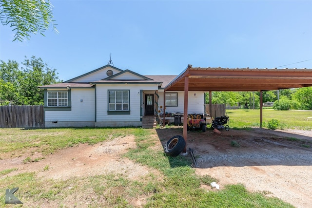 view of front of house with dirt driveway, a carport, and crawl space