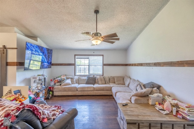 living area featuring a textured ceiling, a ceiling fan, and wood-type flooring