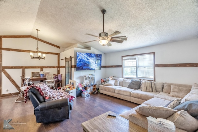 living area with a chandelier, lofted ceiling, a textured ceiling, wood finished floors, and ceiling fan