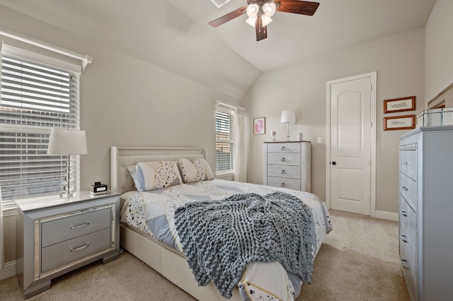 bedroom with light carpet, lofted ceiling, ceiling fan, and baseboards