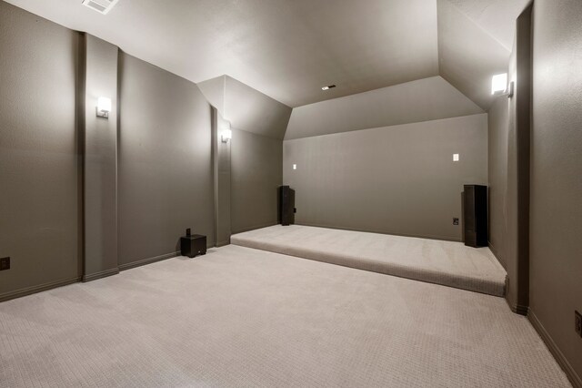home theater with carpet flooring and vaulted ceiling