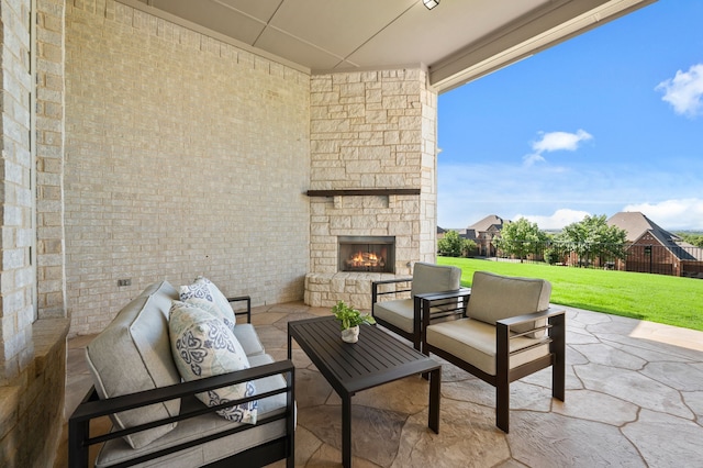 view of patio / terrace with an outdoor living space with a fireplace