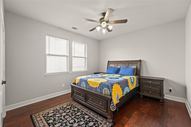 bedroom with baseboards, visible vents, a ceiling fan, and wood finished floors