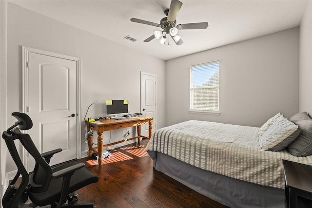 bedroom with baseboards, a ceiling fan, visible vents, and wood finished floors