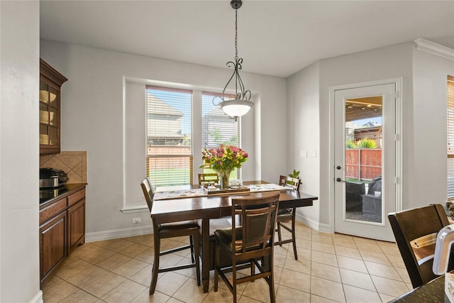 dining space with light tile patterned flooring and baseboards
