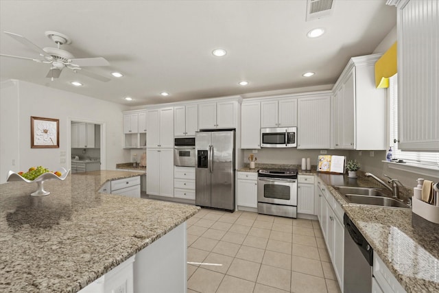 kitchen featuring a sink, stainless steel appliances, visible vents, ceiling fan, and light tile patterned floors