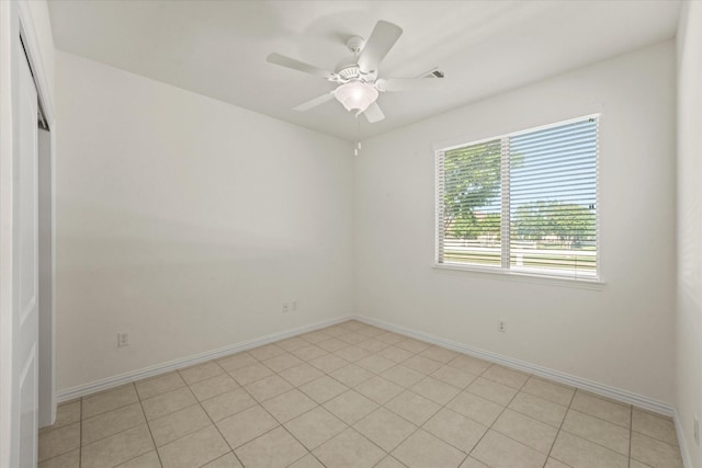 spare room featuring baseboards and ceiling fan
