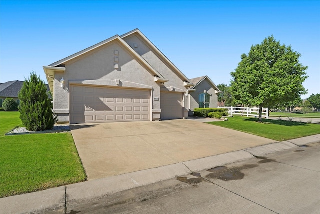 view of front of property featuring a garage, stucco siding, fence, a front lawn, and concrete driveway