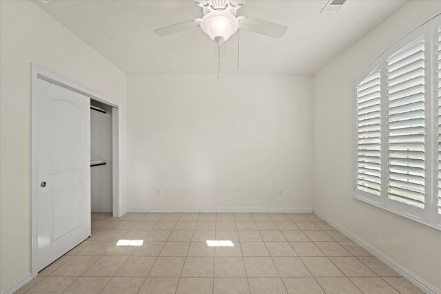 unfurnished bedroom with visible vents, baseboards, light tile patterned flooring, and ceiling fan