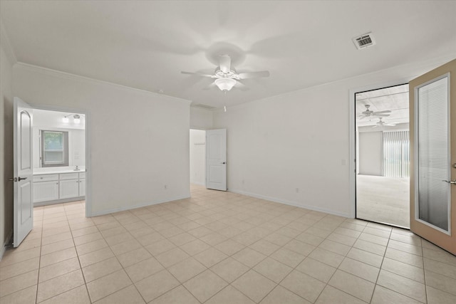 interior space featuring crown molding, a healthy amount of sunlight, ceiling fan, and visible vents