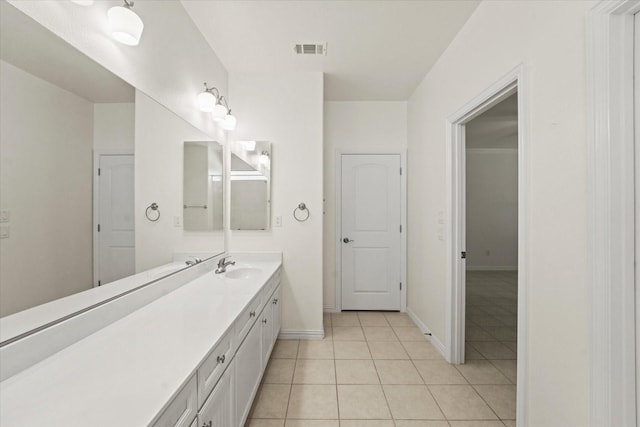 bathroom with tile patterned flooring, baseboards, visible vents, and vanity