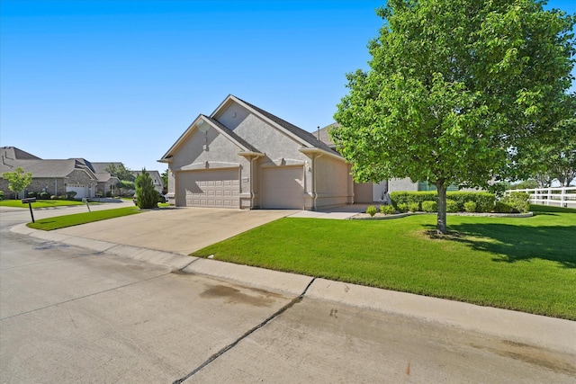 view of front of house featuring driveway, fence, an attached garage, stucco siding, and a front yard