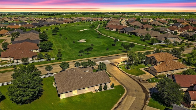 aerial view with golf course view and a residential view