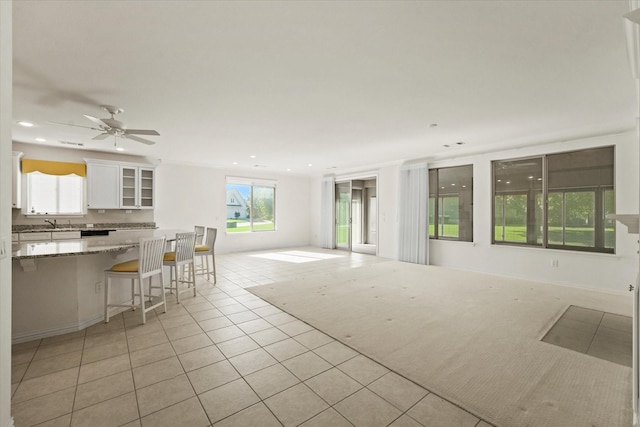 living area featuring ceiling fan, light tile patterned floors, and recessed lighting