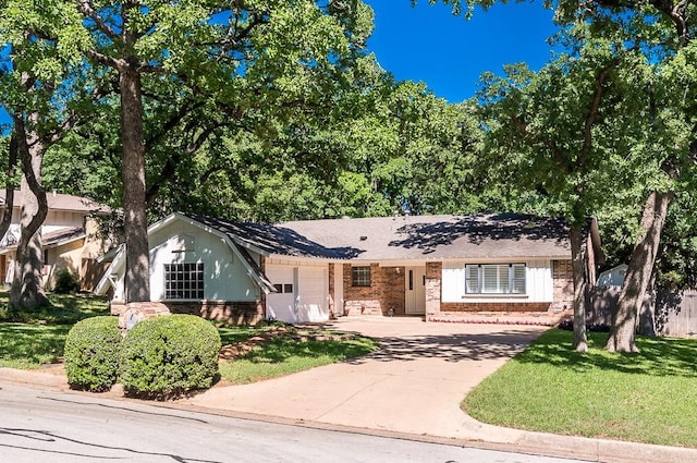 ranch-style home with concrete driveway, an attached garage, a front lawn, and brick siding