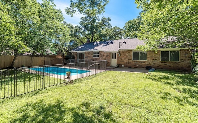 view of swimming pool featuring a lawn, a patio area, a fenced in pool, and a fenced backyard