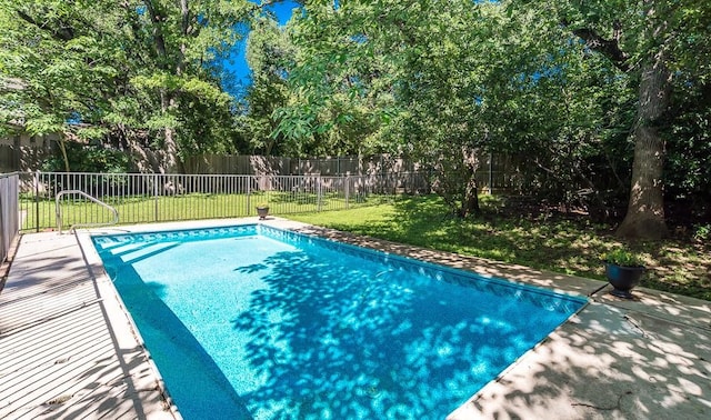 view of swimming pool featuring a lawn, a fenced in pool, and a fenced backyard