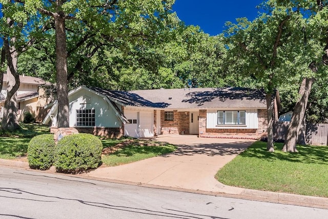 ranch-style home with fence, brick siding, driveway, a garage, and a front lawn