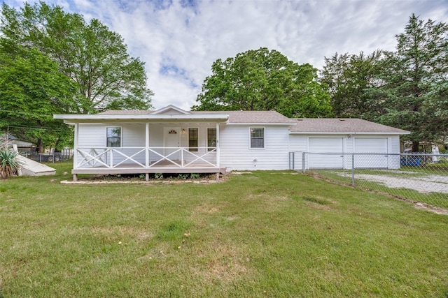 1509 Mitchell Dr, Bonham, TX 75418 - view of front of house with a front lawn, roof with shingles, covered porch, and fence