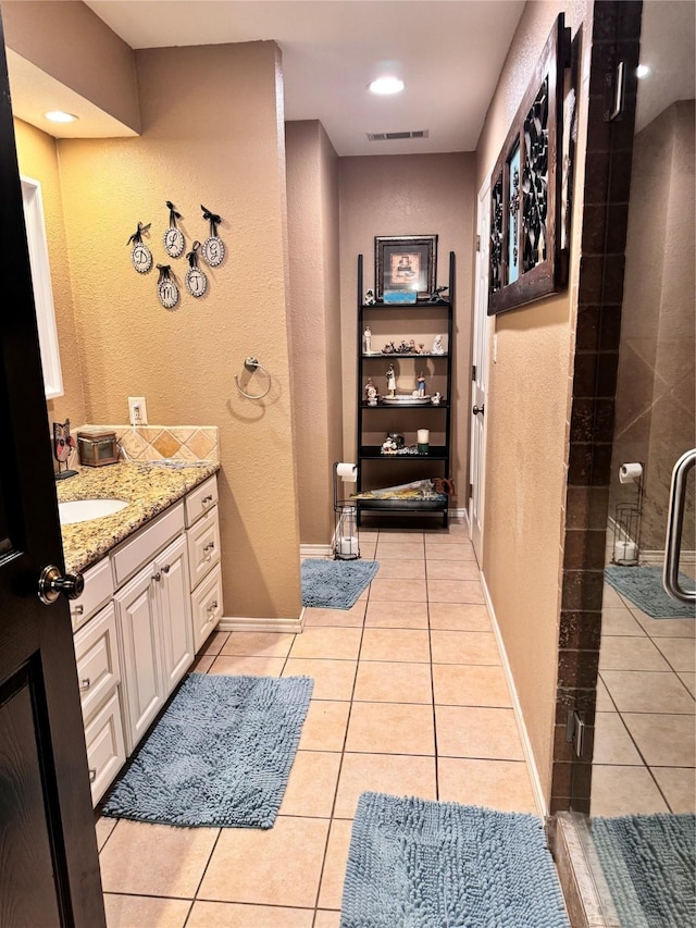 bathroom featuring tile patterned flooring, a shower stall, visible vents, and vanity
