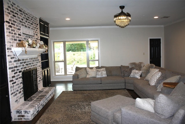 living room with dark wood-style flooring, a fireplace, ornamental molding, and recessed lighting
