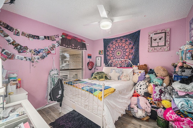 3811 Pelham Mnr, Arlington, TX 76016 - bedroom featuring ceiling fan, a textured ceiling, and wood finished floors