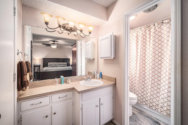 3811 Pelham Mnr, Arlington, TX 76016 - bathroom with connected bathroom, toilet, a ceiling fan, a textured ceiling, and vanity